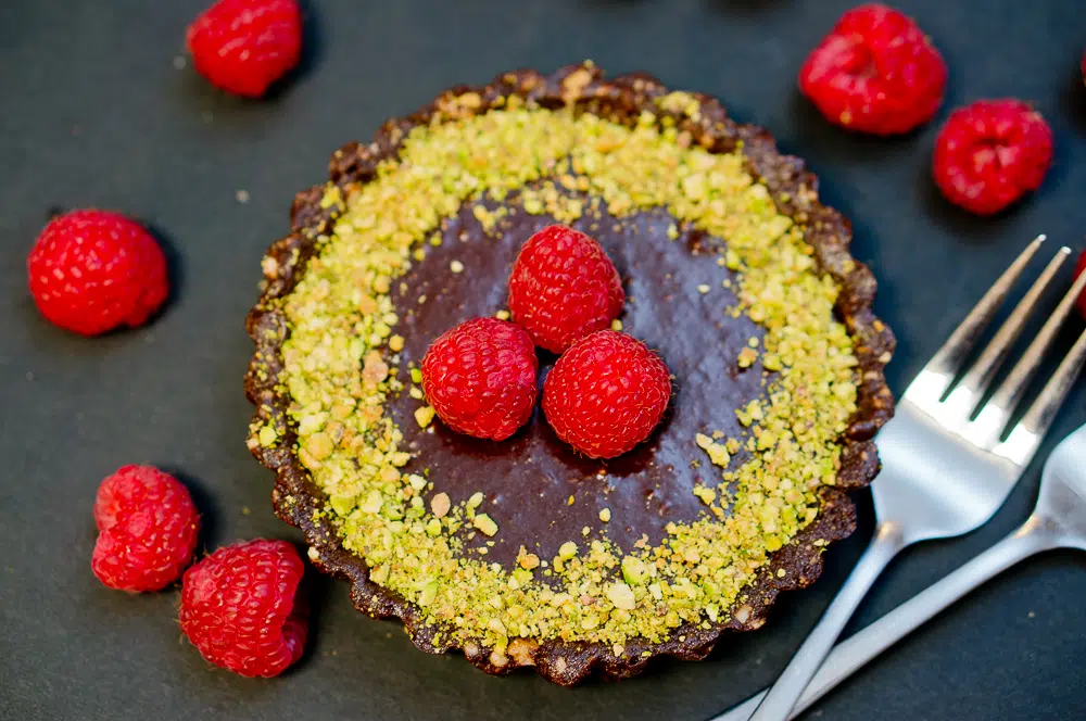 No Bake Chocolate Tarts topped with fresh berries and pistachios