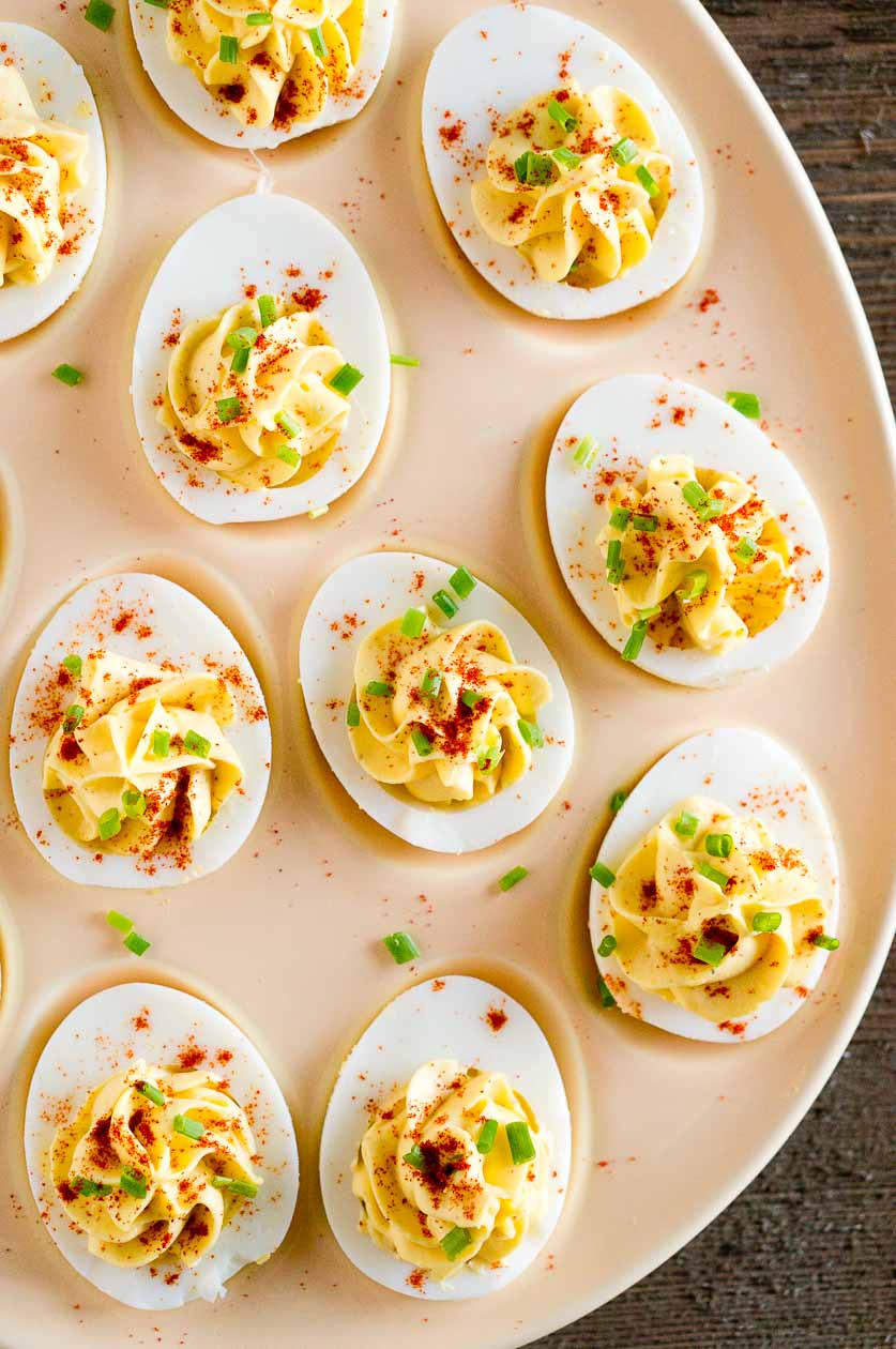 Close up of deviled eggs appetizer with paprika and chives