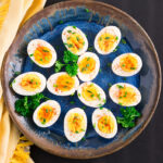hard boiled eggs with bright yellow yolks on a plate
