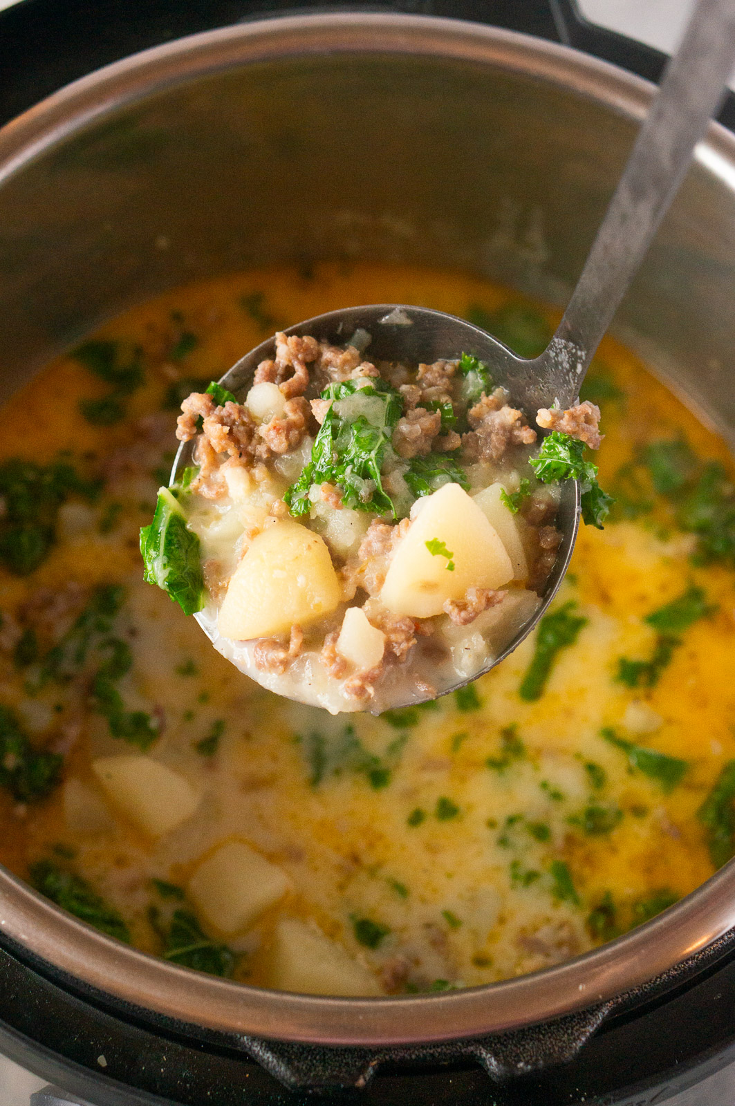 serving Italian potato and sausage soup from an Instant Pot