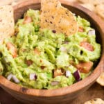 close up of easy avocado dip in a wooden bowl