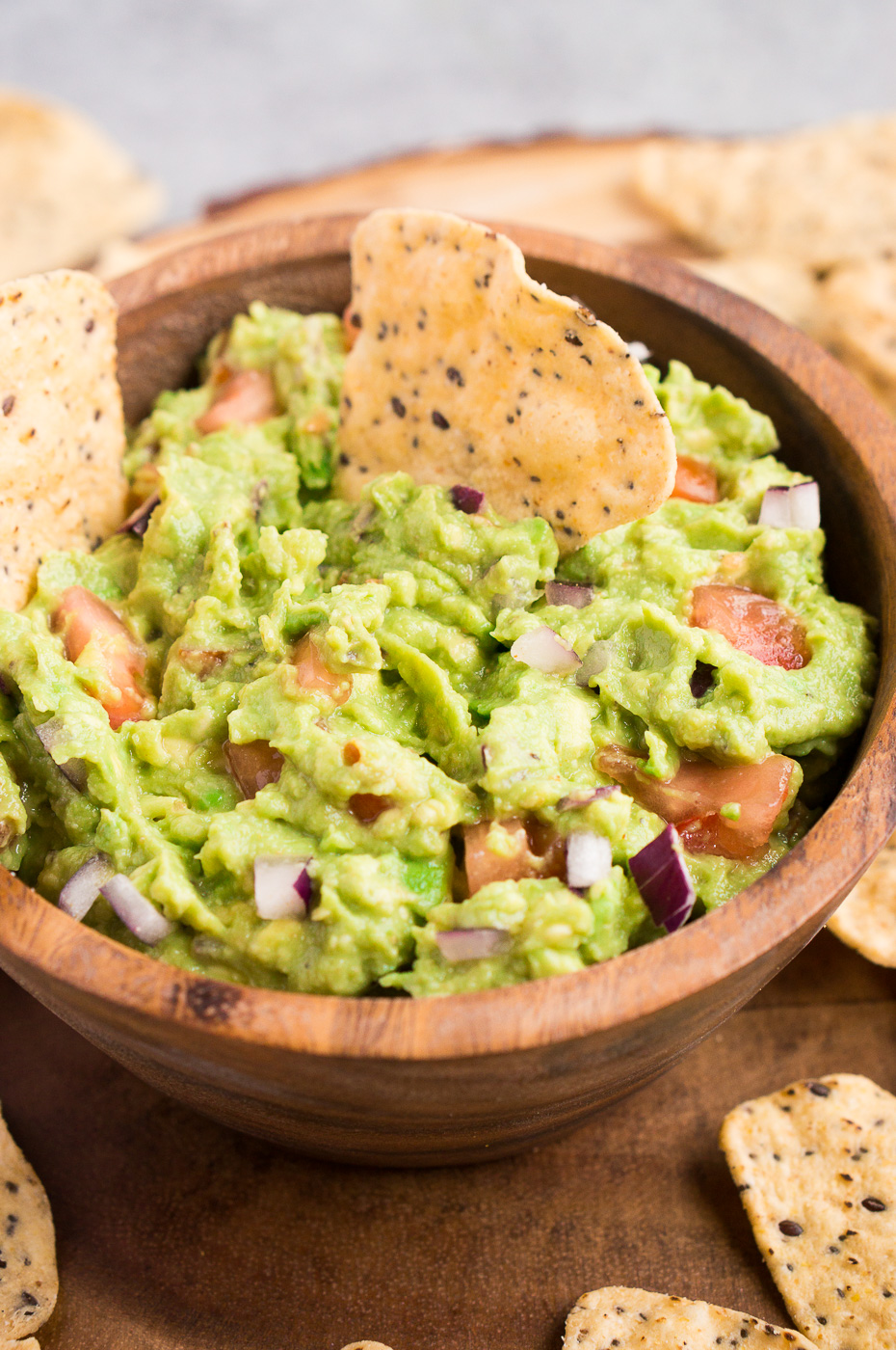 close up of easy avocado dip in a wooden bowl