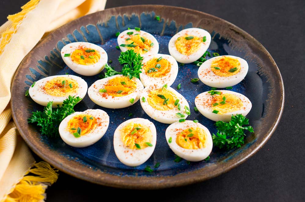 boiled eggs on a blue plate with yellow towel