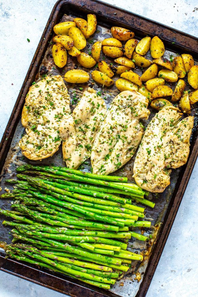Baked Chicken and Asparagus on a baking sheet