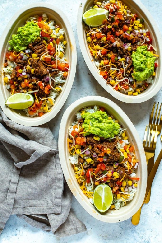 3 bowls of barbacoa beef with taco toppings