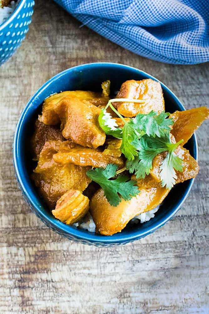 chicken curry made in an Instant Pot - served in blue bowl