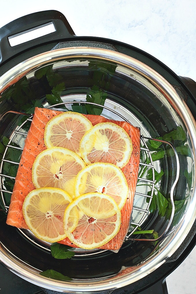 lemon pepper salmon filet topped with lemon in Instant Pot