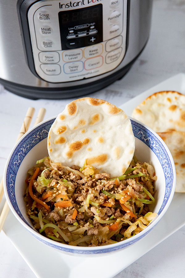 bowl of egg roll filling next to Instant Pot