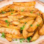 close up of baked potato wedges on a plate