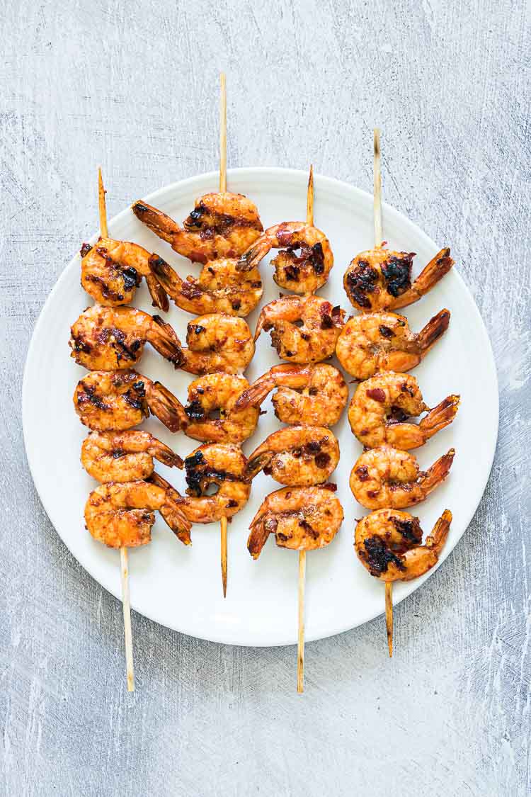 shrimp skewers on a white plate
