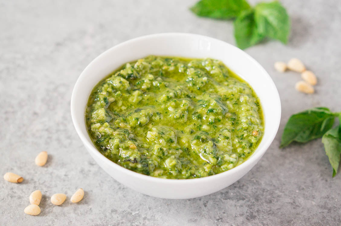 pesto sauce recipe in a bowl with basil & pinenuts
