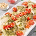 pesto chicken on a white platter