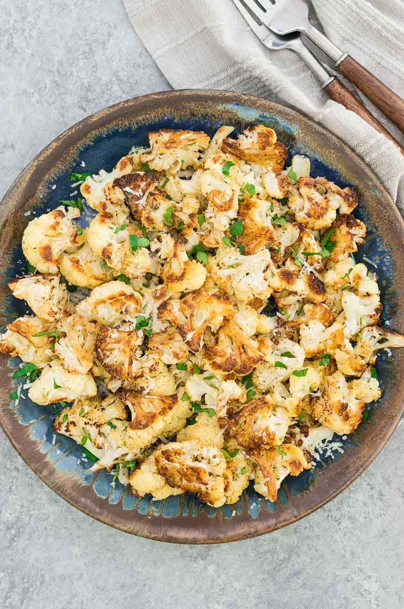 oven baked cauliflower with crispy edges on a blue plate