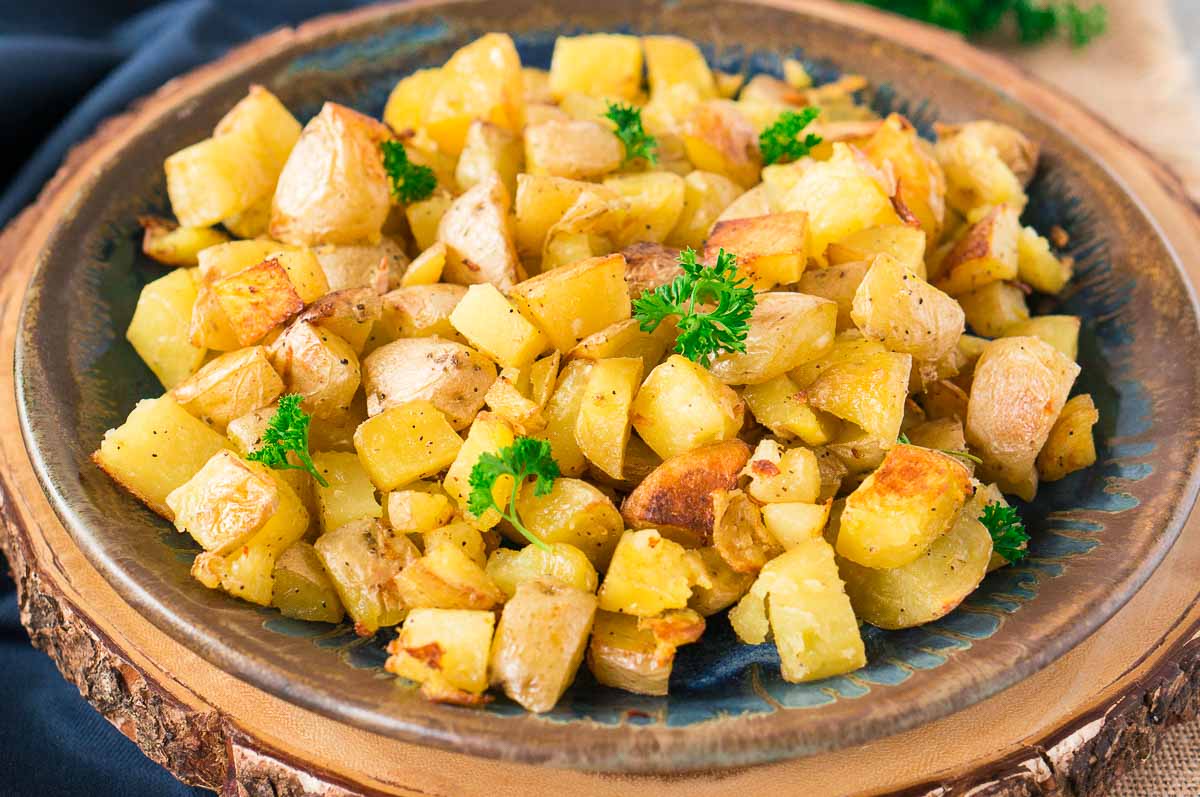 garlic roasted potatoes in the oven with crispy edges