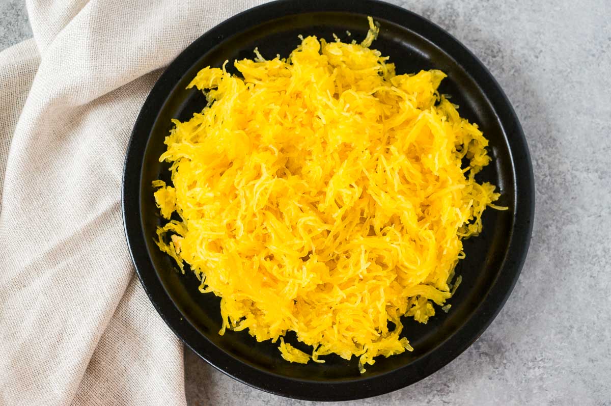 cooked spaghetti squash on a black plate