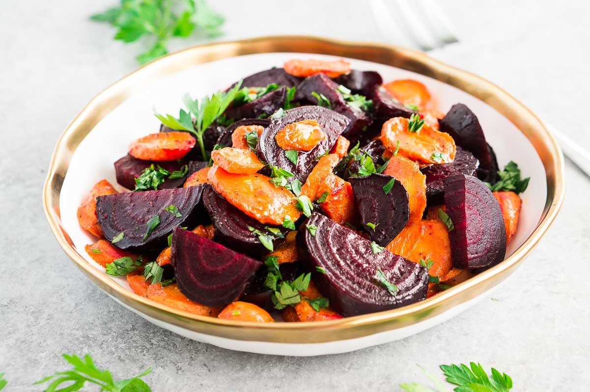 beets and carrots in a bowl on a gray board