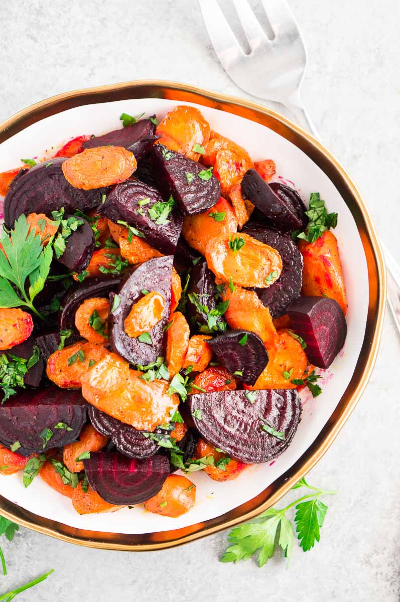 roasted beets and carrots - thanksgiving side dish served in a white bowl and fork