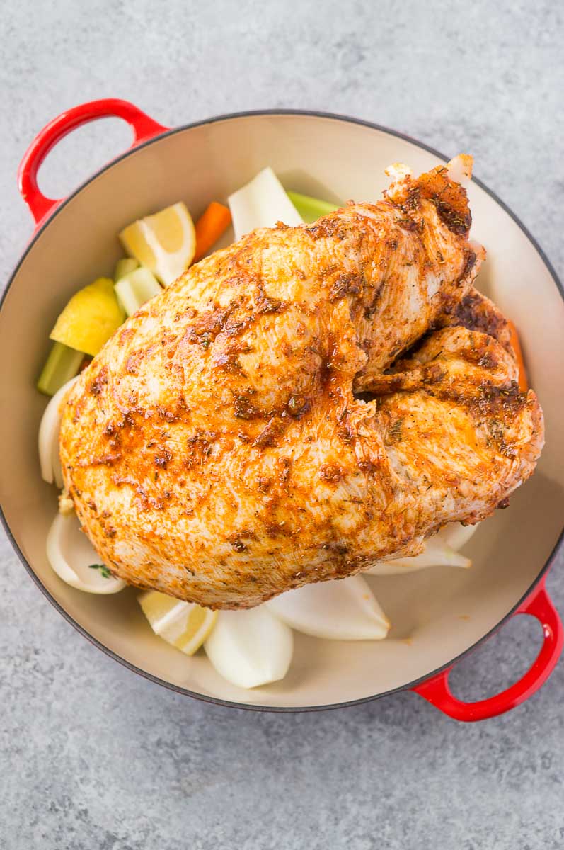 Turkey breast over vegetables in a roasting pan