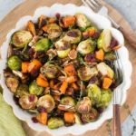 roasted butternut squash and brussel sprouts for thanksgiving in a white bowl