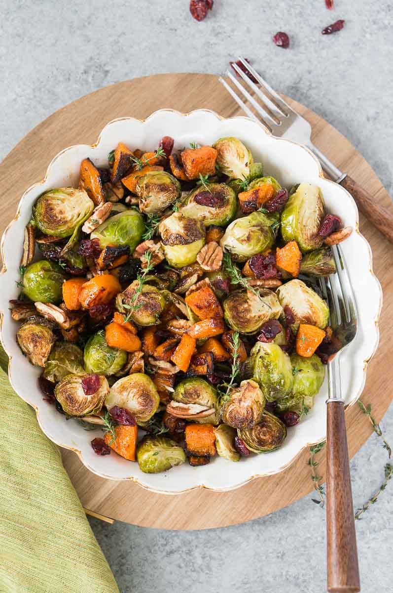 roasted butternut squash and brussel sprouts for thanksgiving in a white bowl
