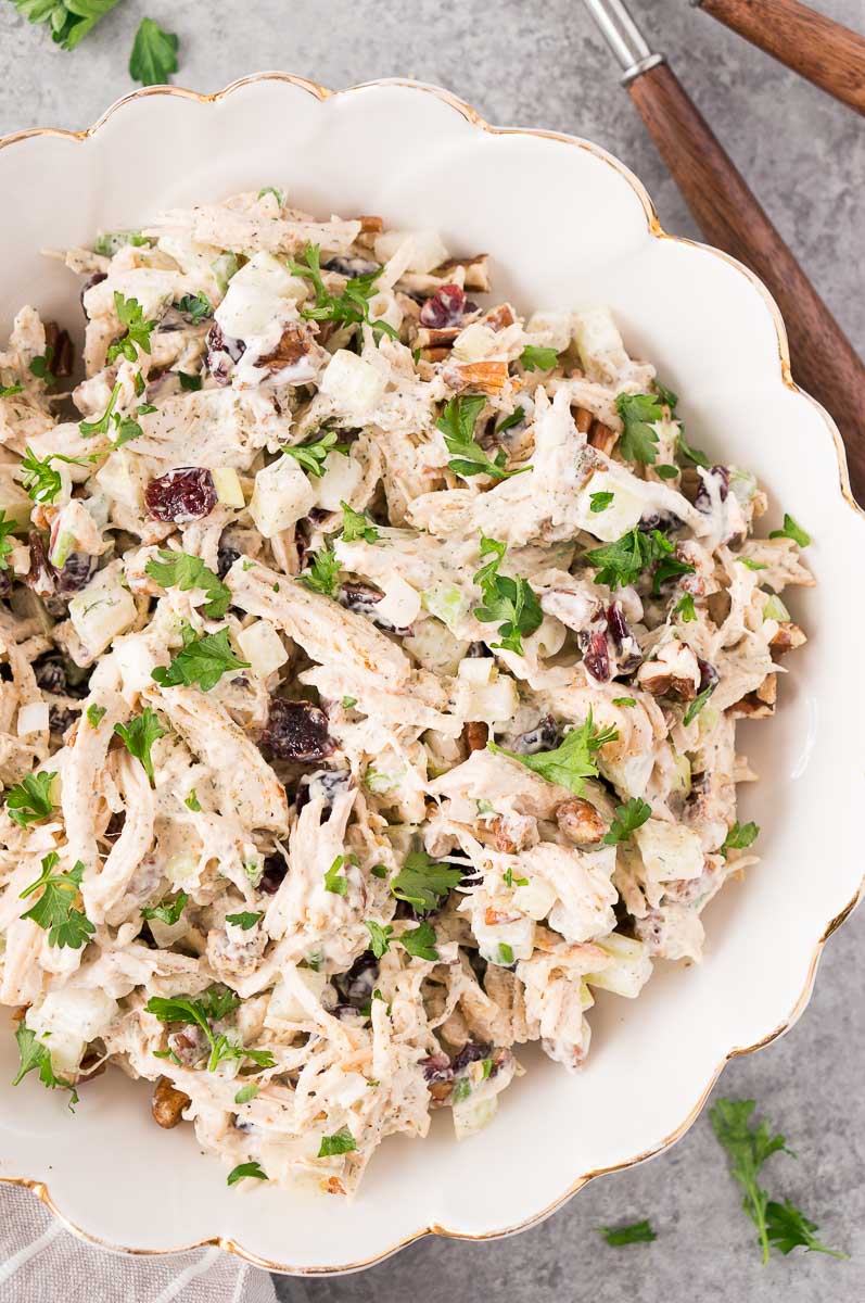 a white bowl of leftover turkey salad with cranberries