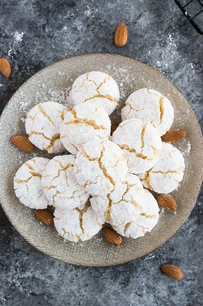 amaretti cookies on a plate with raw almonds