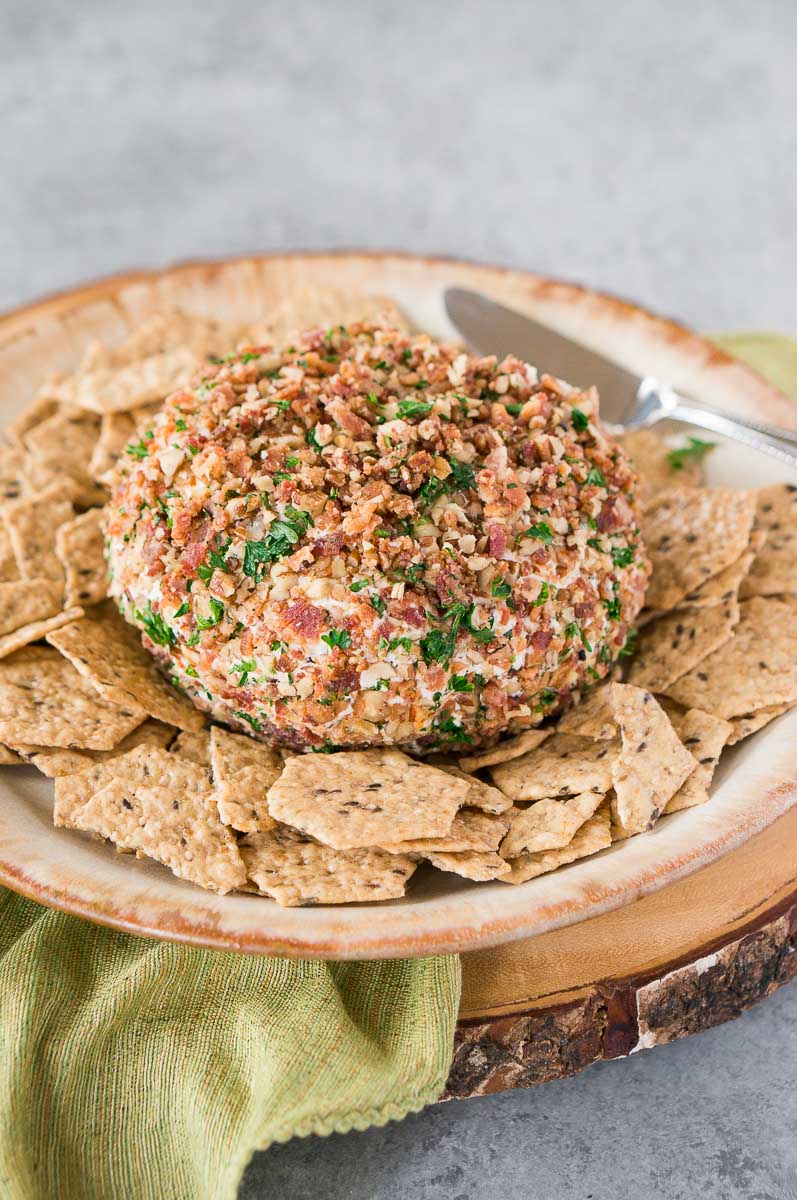 simple cheese ball with bacon pecan coating served with crackers