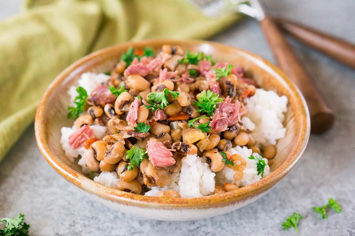 instant pot hoppin john over rice in a bowl