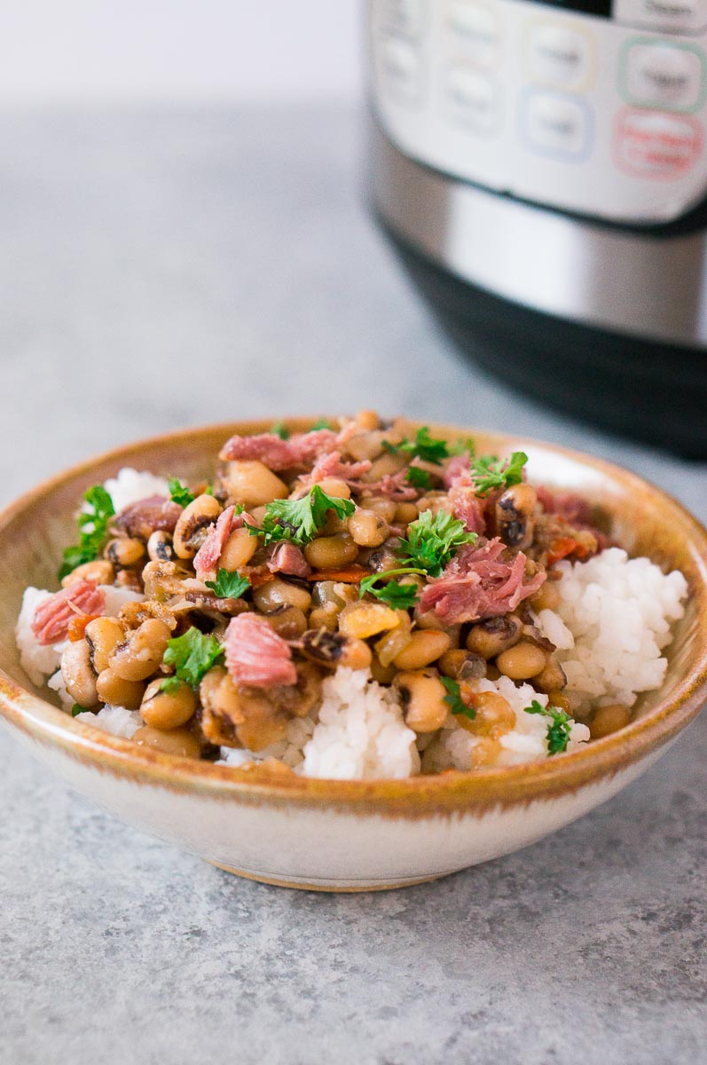 black eyed peas and ham over rice in a bowl