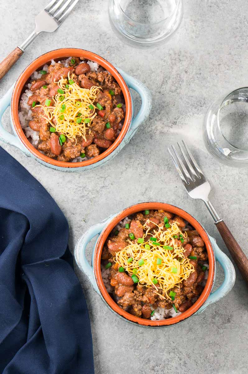 two bowls with bean chili over rice