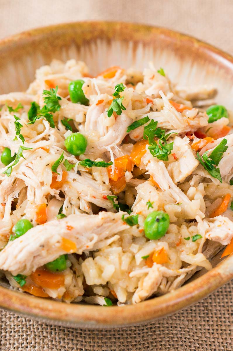 close up of chicken and rice in a clay bowl