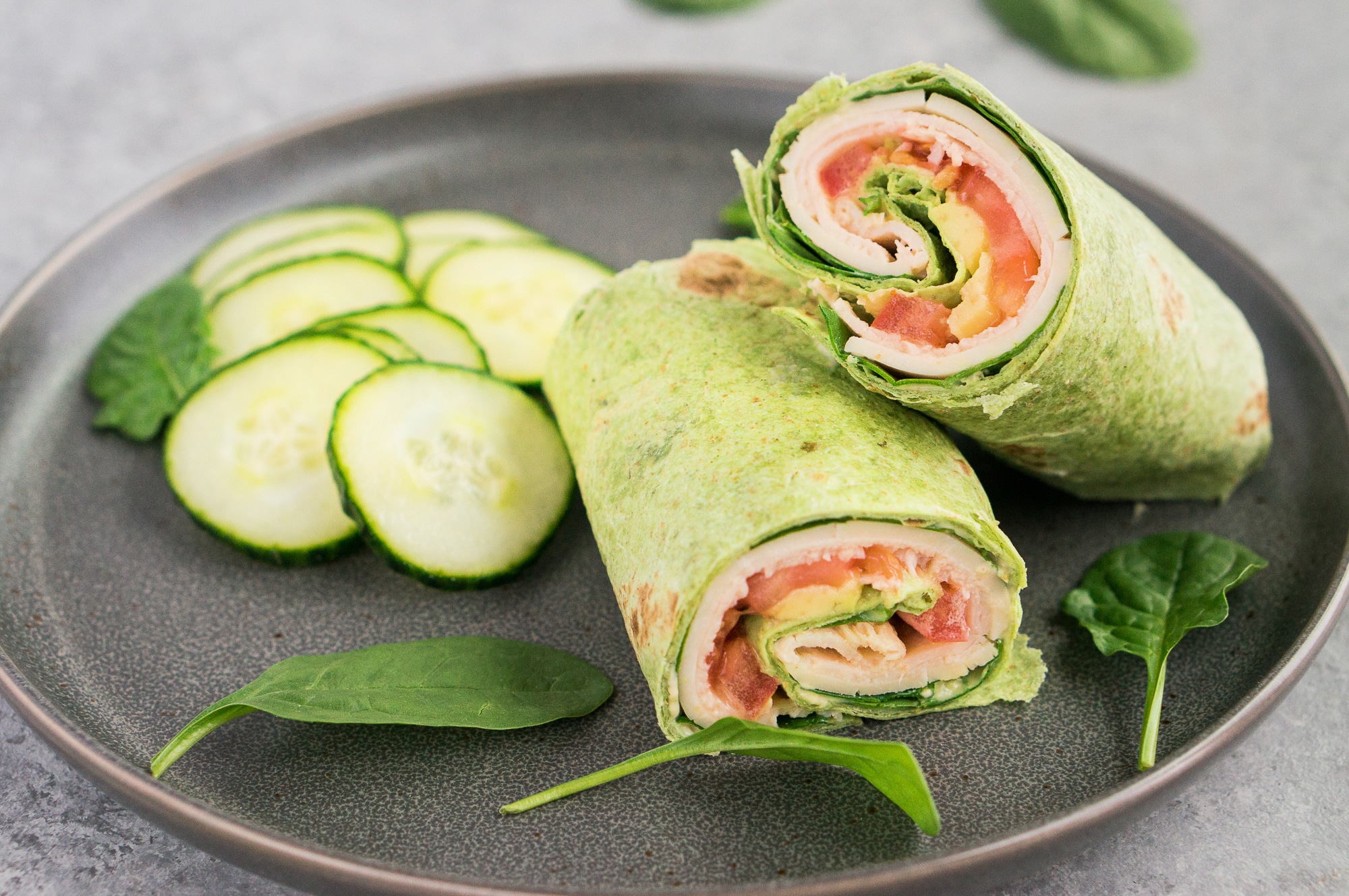 sliced turkey wrap with cucumber on a plate
