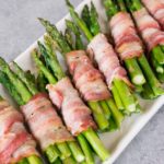 bacon wrapped asparagus bundles on a platter