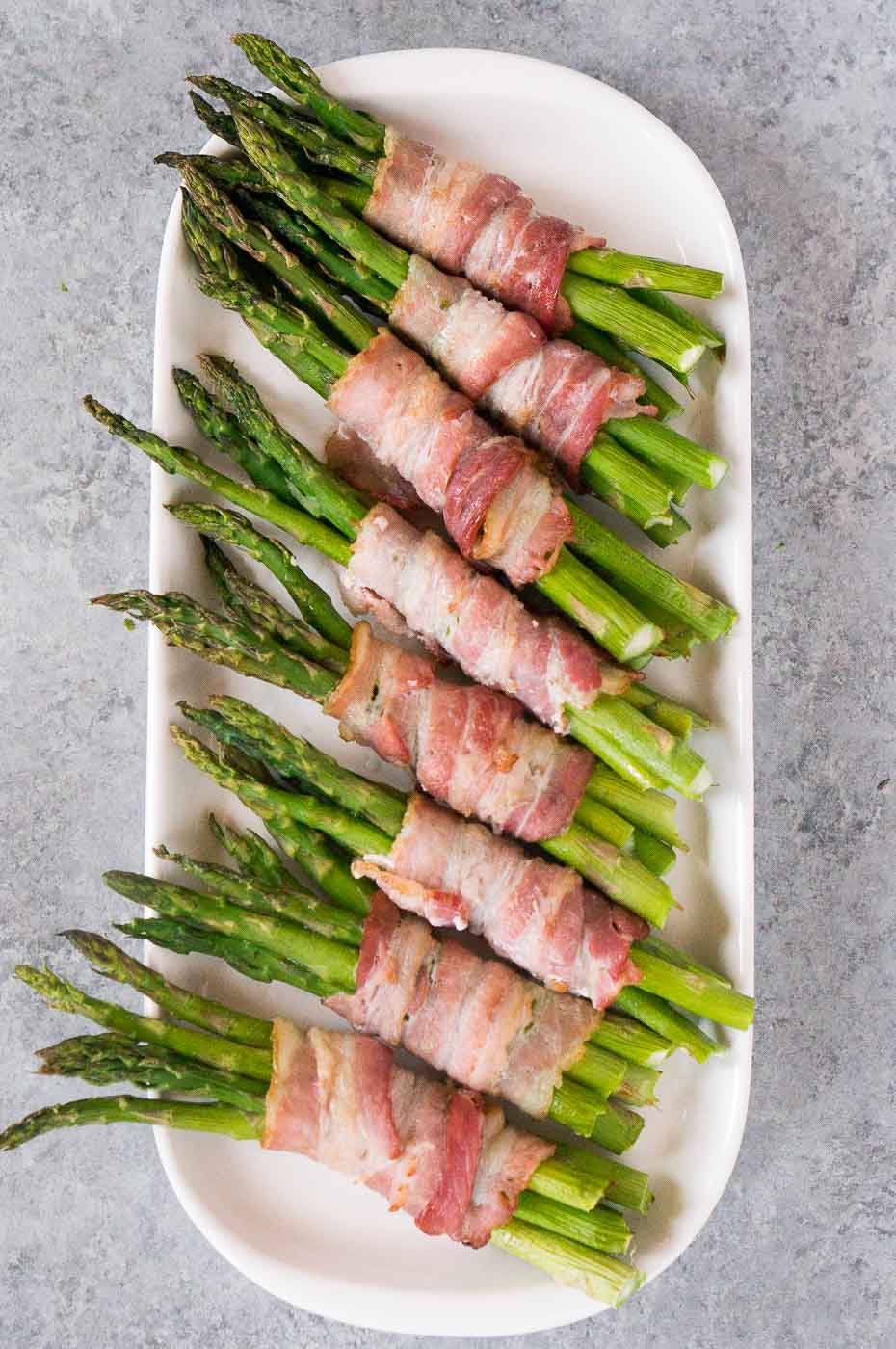 asparagus wrapped in bacon on a plate