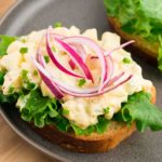 egg salad on a slice of bread with lettuce