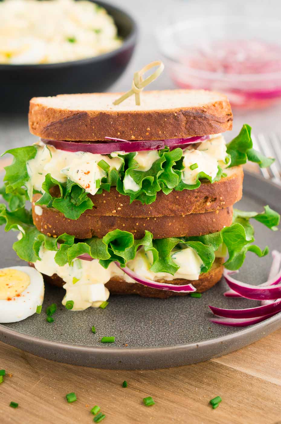 egg salad sandwiches stacked on a plate