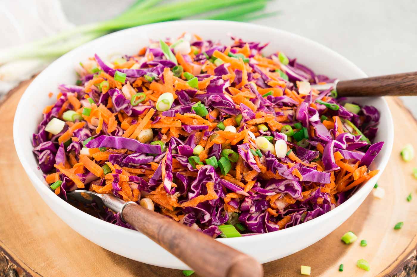 red cabbage and carrots salad in a white bowl