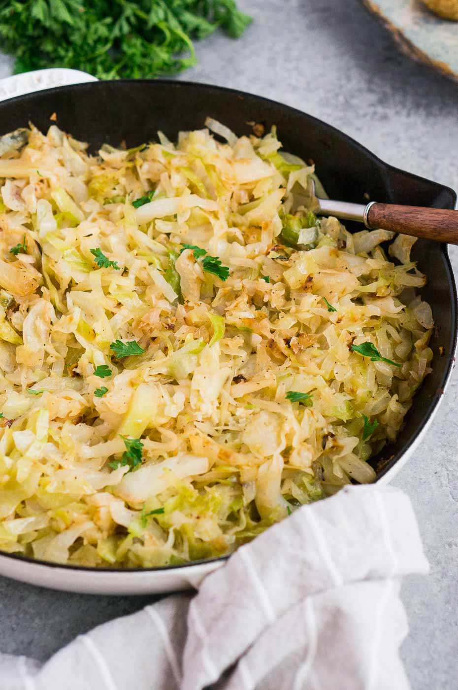 sauteed cabbage in a white skillet