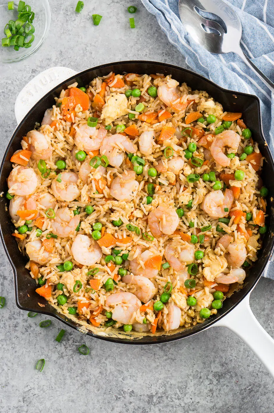 A large skillet filled with a freshly prepared shrimp and rice dish, ready to be dished out and enjoyed.