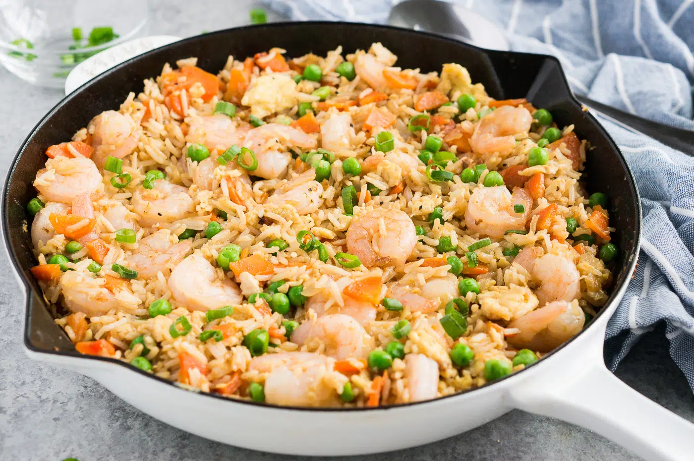 Shrimp fried rice beautifully arranged in a white skillet, ready to be served, highlighting its appealing presentation.