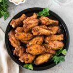 baked chicken wings with spice rub served on a black plate