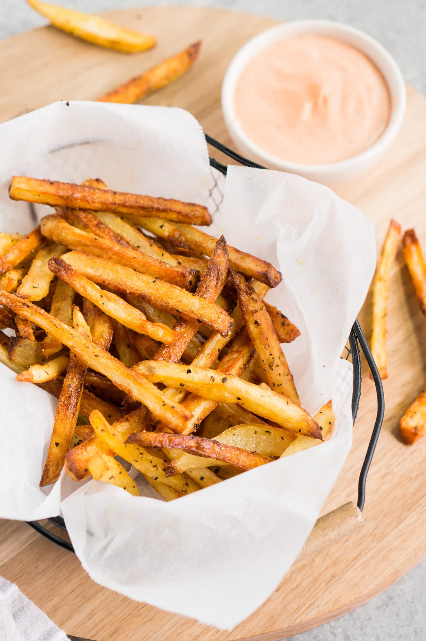 French fries in a basket with fry dipping sauce