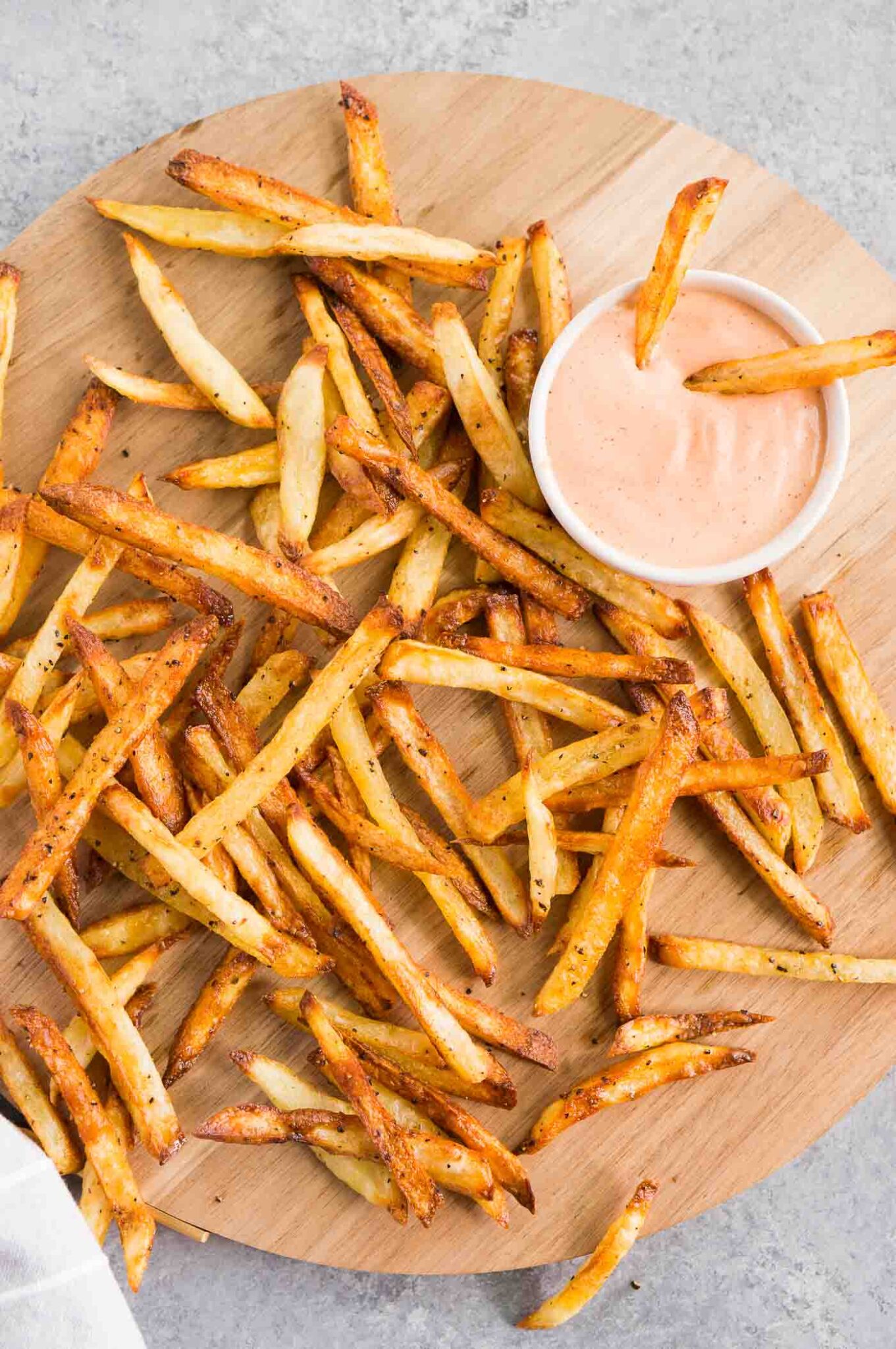 best homemade french fries serve on a board with dipping sauce