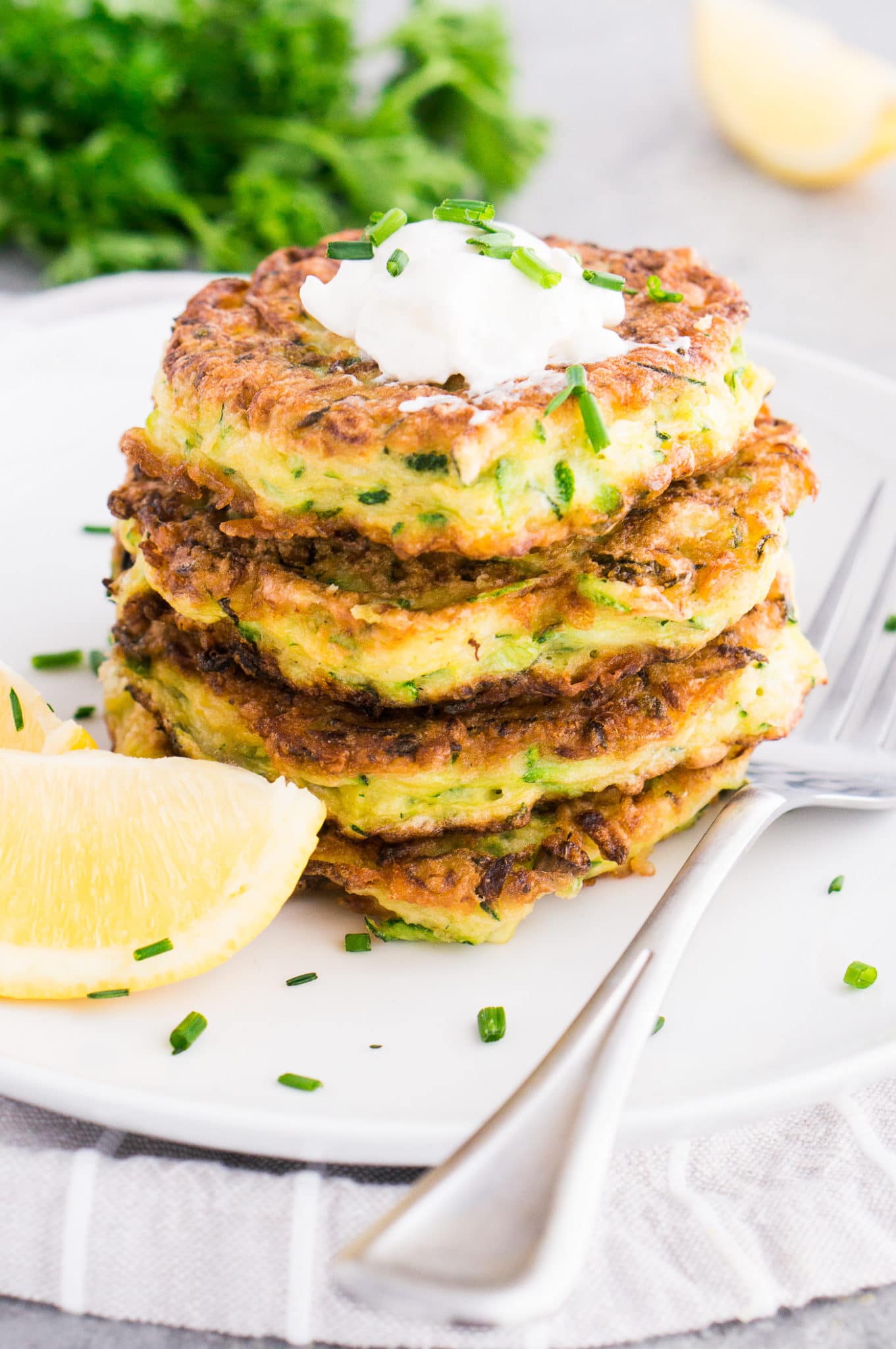 stacked zucchini patties with sour cream