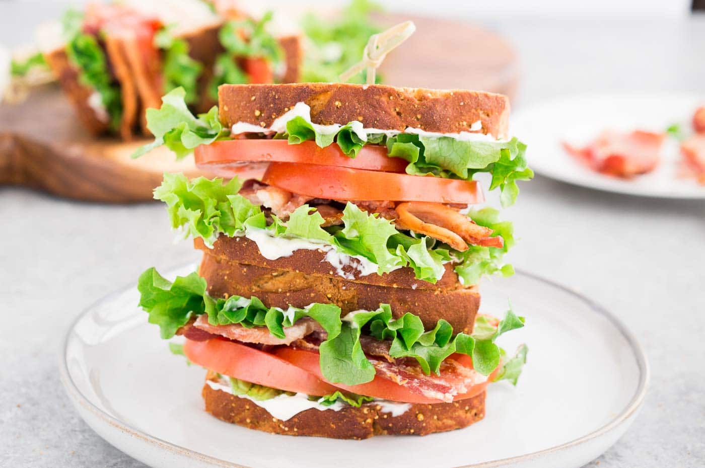 stacked homemade BLT sandwich on a plate