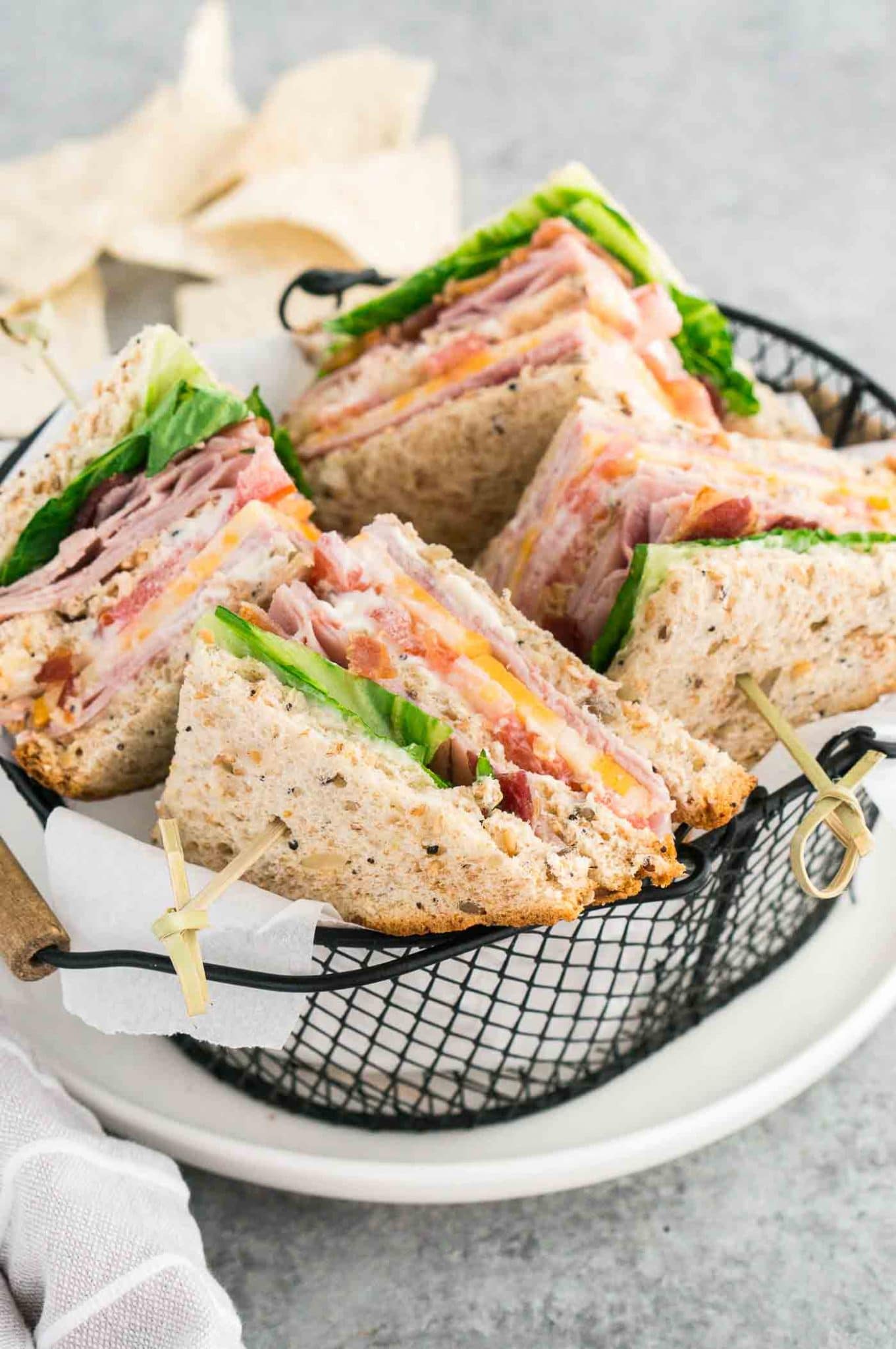 club sandwiches cut in triangles in a basket
