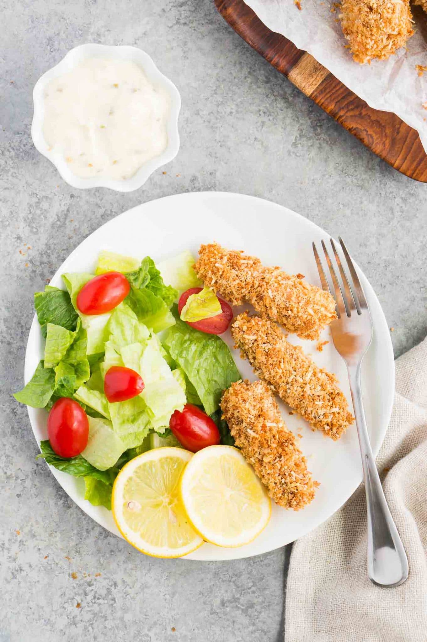 cod fish sticks with salad on a plate