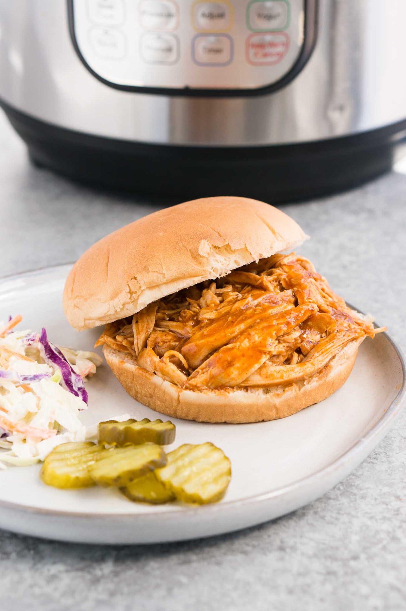 instant pot bbq chicken served on a bun on a plate