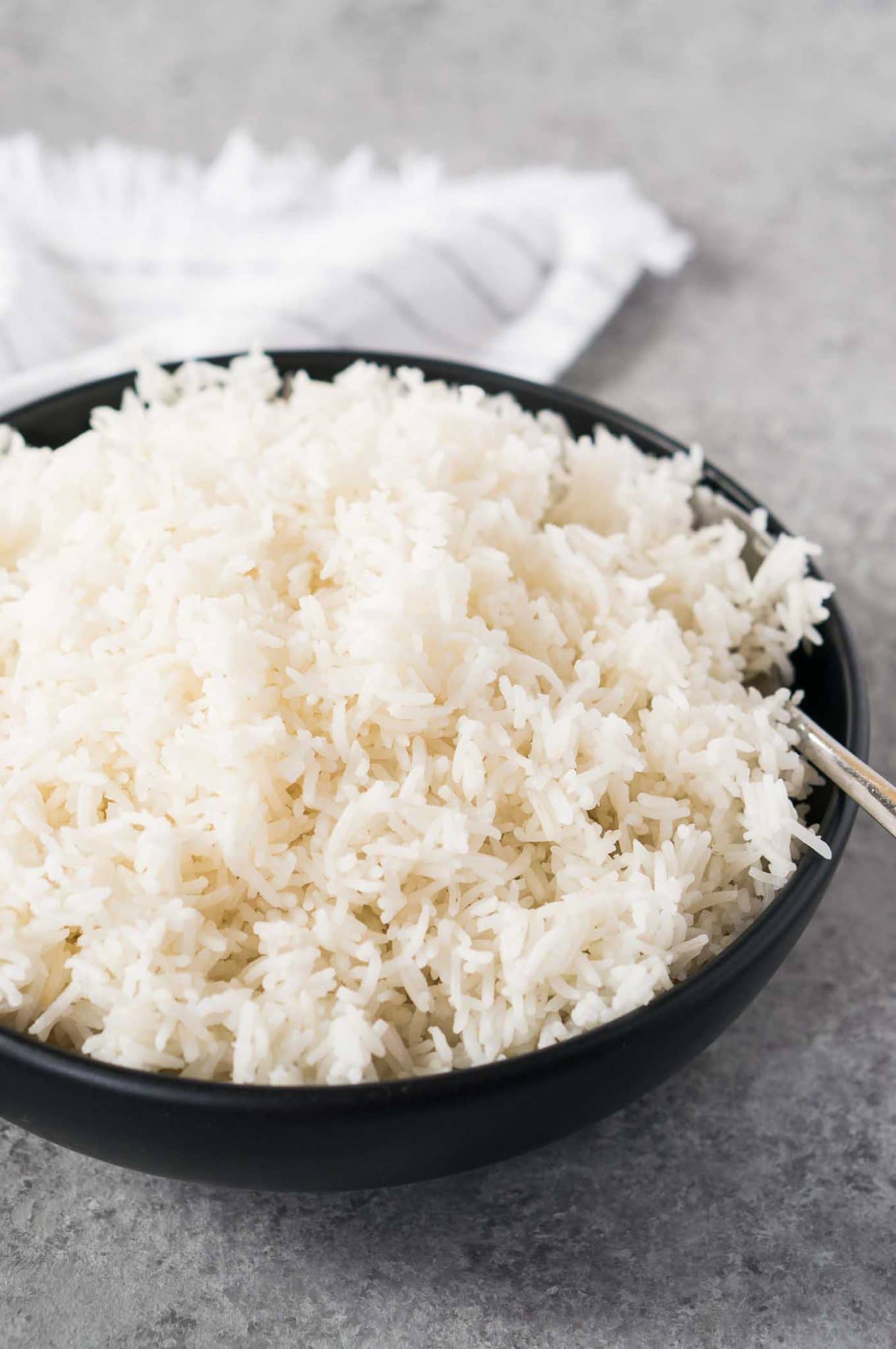 fluffy rice made in a instant pot served in a black bowl