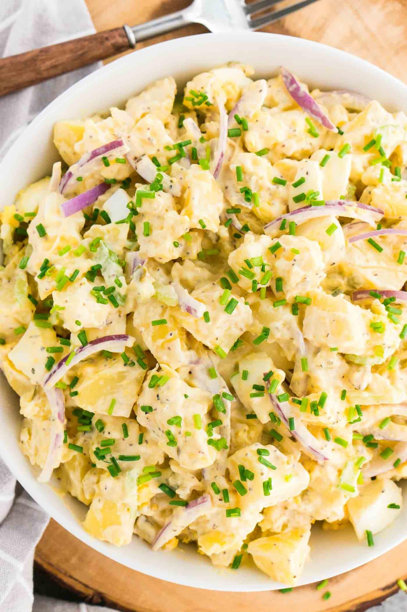 quick and easy potato salad in a white bowl and a fork
